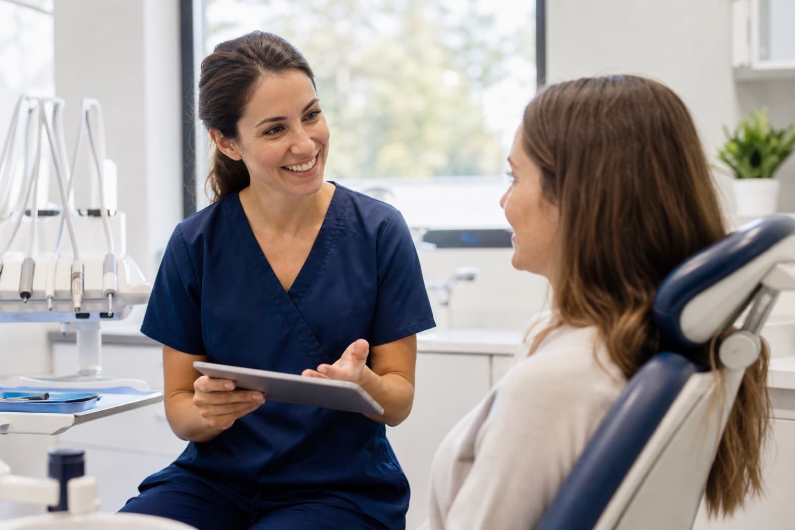 Dentist consulting warmly with a patient in a bright modern practice
