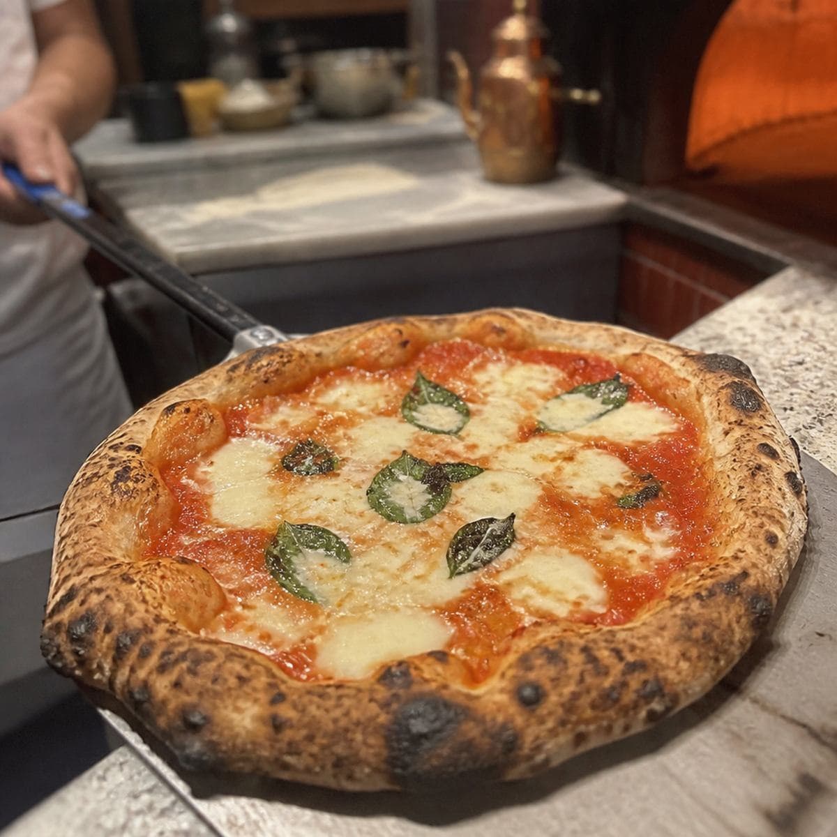 Pizzeria owner pulling a fresh pepperoni pie from the oven