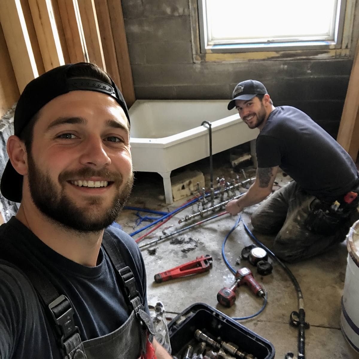 Plumbing crew standing in front of their service van