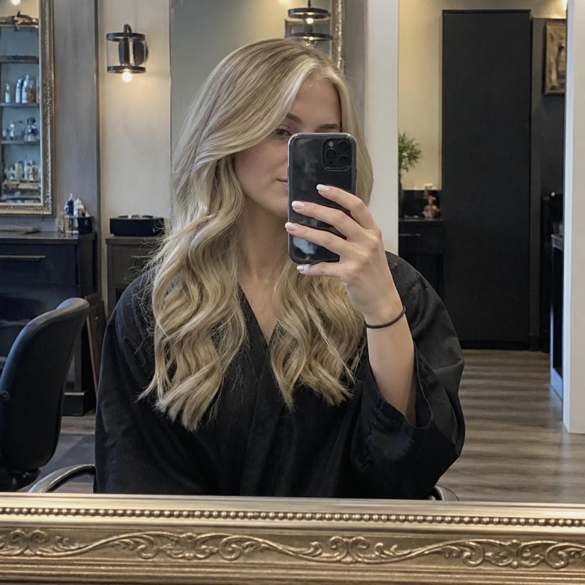 Salon stylist showing a finished hair transformation for a local client