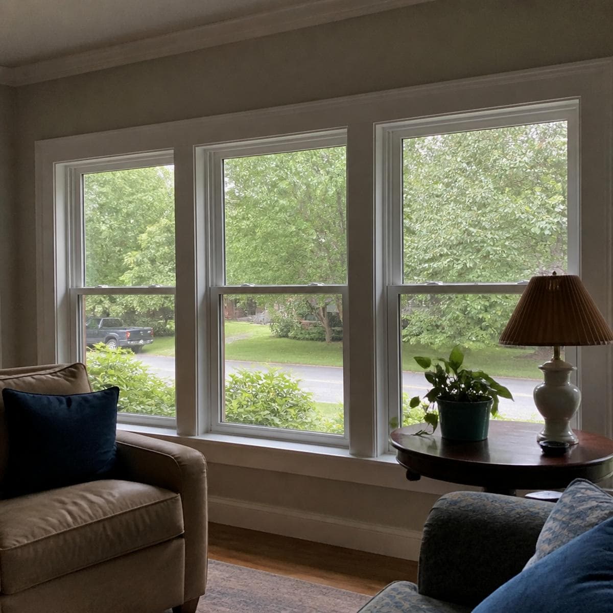 Window and door installer reviewing a completed front door replacement with a homeowner