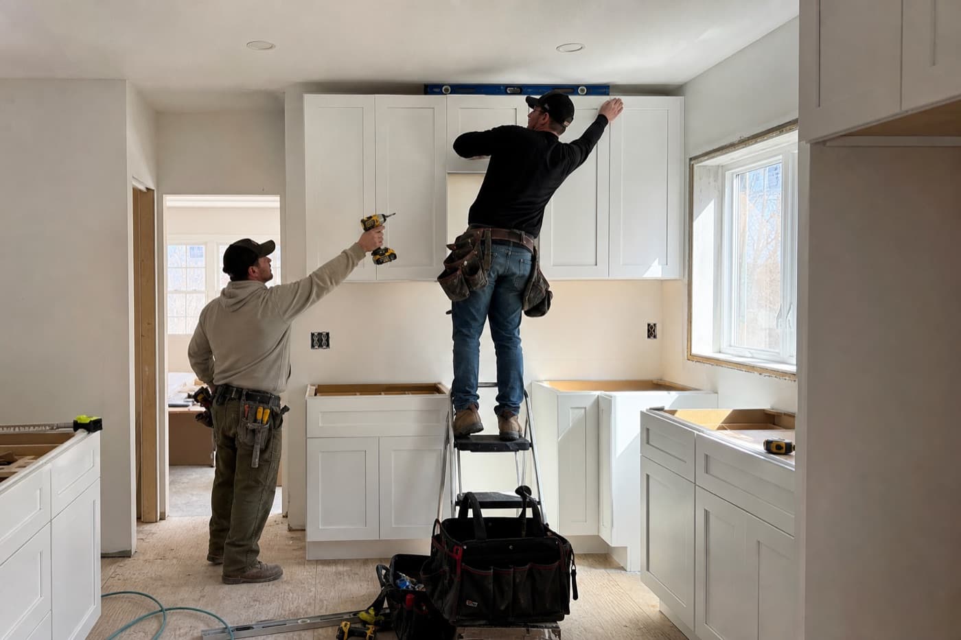 Remodeling crew installing custom cabinets